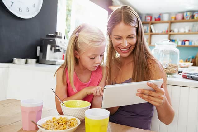 Mom and Daughter Using Tablet in the Kitchen